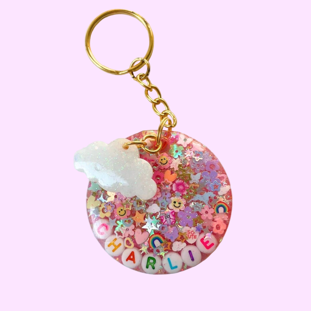 pink circle glitter keychain with small sparkle cloud