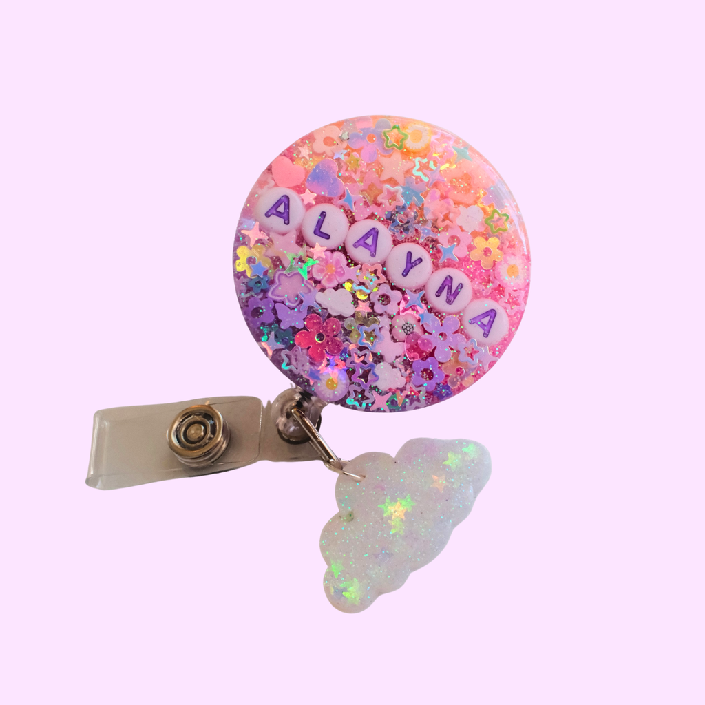 Colorful badge holder with 'ALAYNA' on a pink background