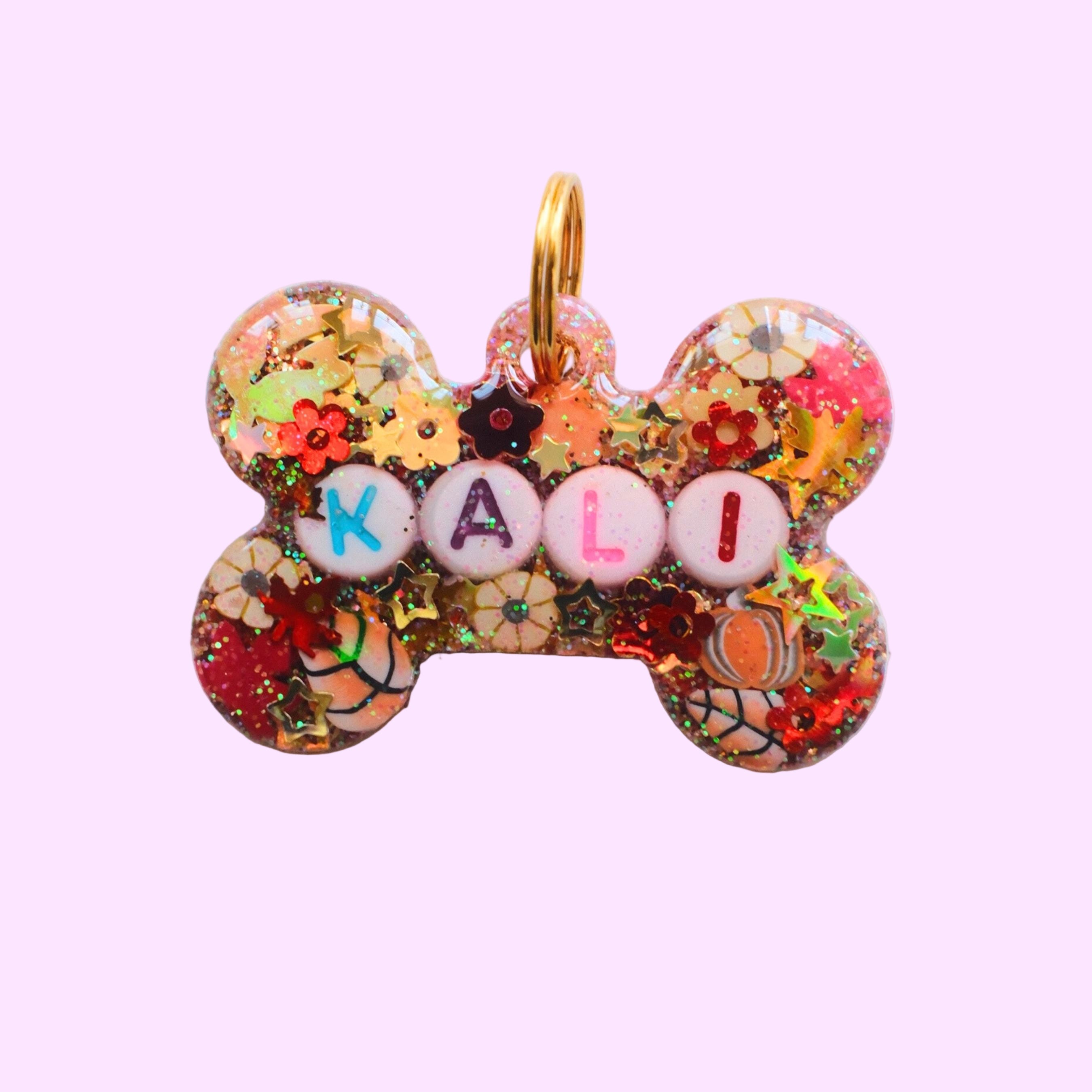 gold and orange resin bone shaped pet tag with autumn and fall themed glitter - pumpkin spice 