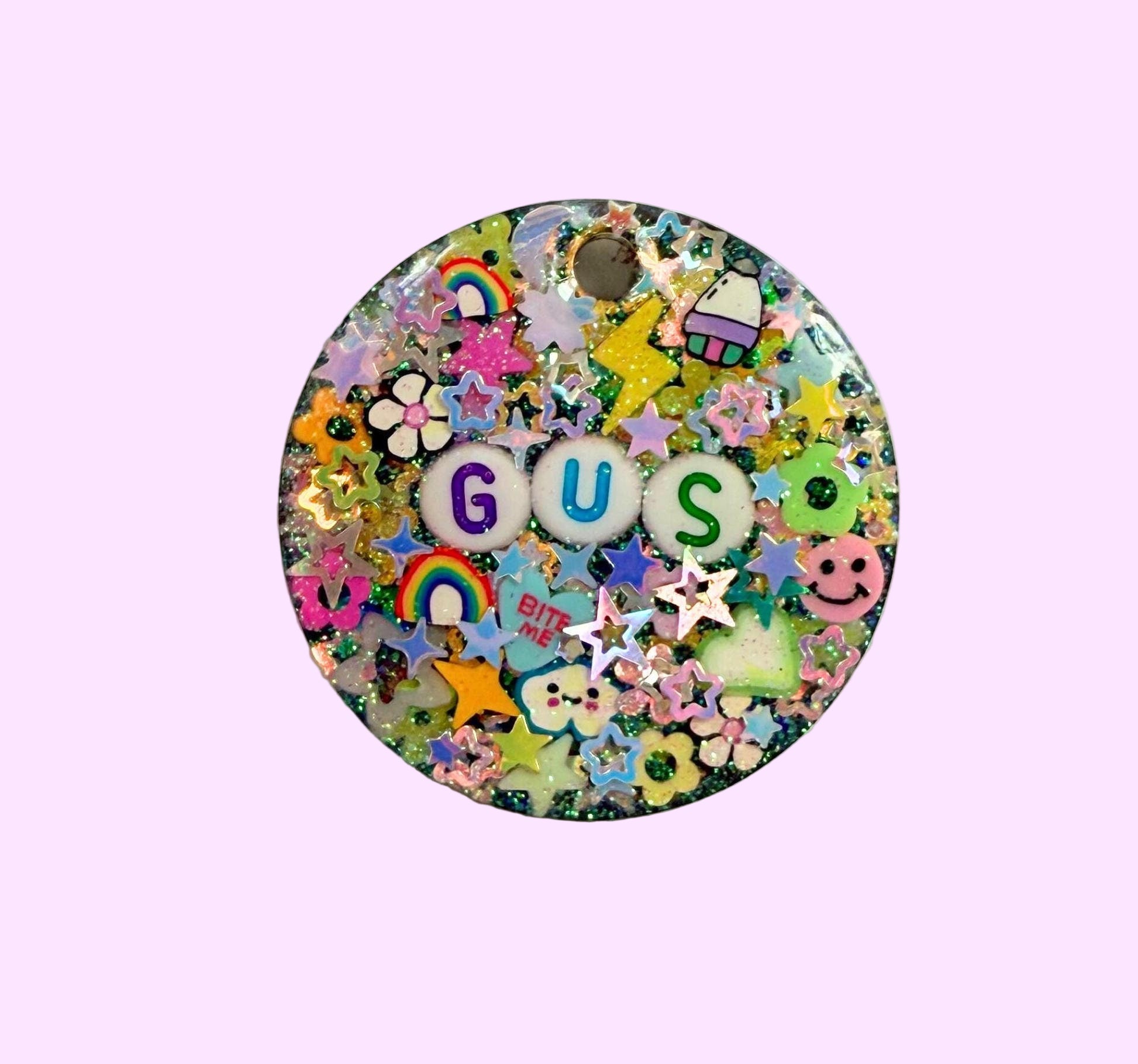 round pet tag with a black resin base filled with colorful glitter