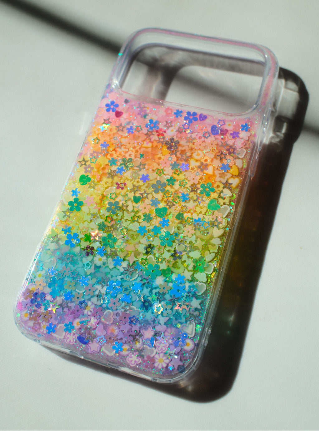 Phone case with colorful glittery design on a white background