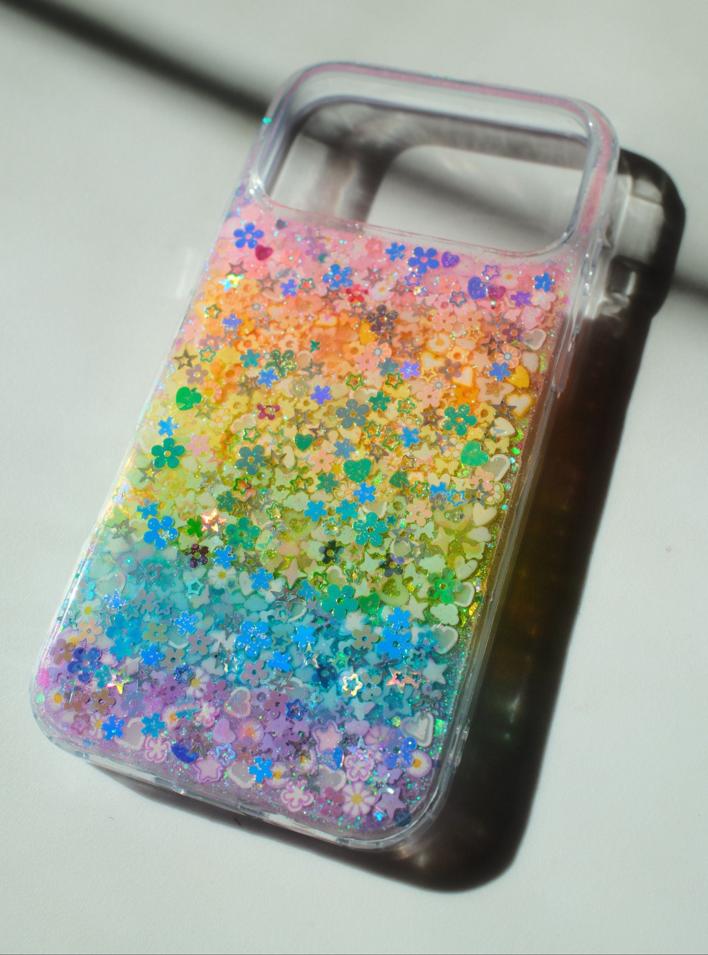 Phone case with colorful glittery design on a white background