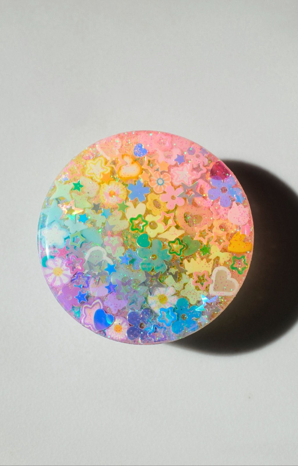 pastel monochromatic phone grip on a white background in direct sunlight